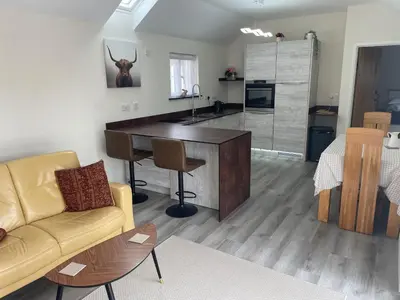 a living room with a couch and a desk at Sunnyside Cow Shed one bedroom central Cornwall in Truro