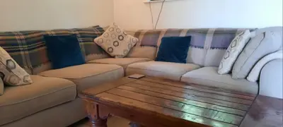 a living room with two couches and a coffee table at Trelake Cottage in Tintagel