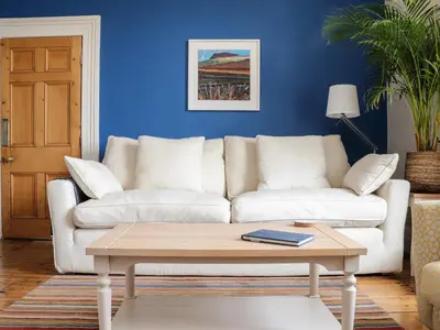a living room with a white couch and a coffee table at The Water House in Falmouth