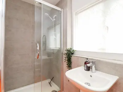 a bathroom with a sink and a shower at The Water House in Falmouth