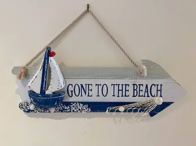 a sign that says gone to the beach with a boat at Lovely 2 Bedroom flat moments from Fistral Newquay in Newquay