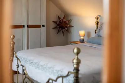 a bedroom with a bed with a star on the wall at Deerpark, Guest House in Padstow