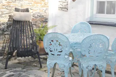 a blue table and chairs sitting on a patio at Sunny Corner in Port Isaac