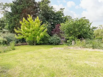a field of grass with trees in the background at The Cottage in Bodmin