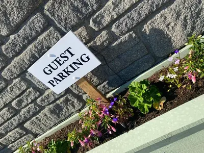 a sign that says guest dancing next to some plants at Meadowview Cottage, Garden View in Camborne