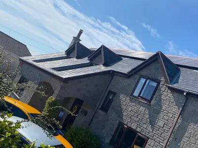 a house with a roof with a chimney on it at Meadowview Cottage, Garden View in Camborne