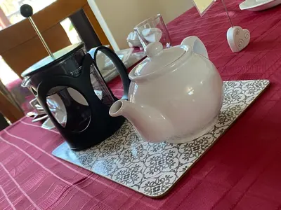 a black and white tea pot on a table at Meadowview Cottage, Garden View in Camborne