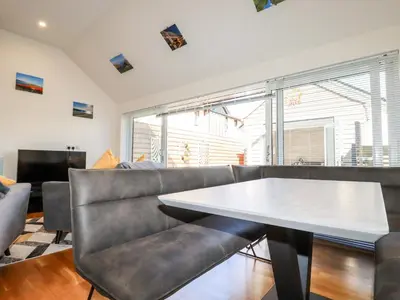 a living room with a couch and a table at Clonmore in Bodmin