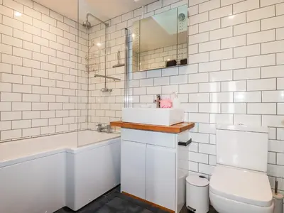 a bathroom with a sink and a tub and a toilet at Clonmore in Bodmin