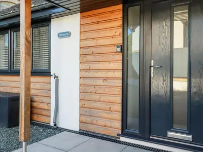 a pivot door of a home with wooden panels at Clonmore in Bodmin
