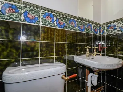 a bathroom with a toilet and a sink at Pen-Y-Thon House in Newquay