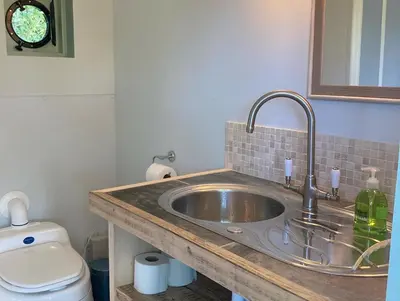 a bathroom with a sink and a toilet at The Hobbit Hole in Zelah