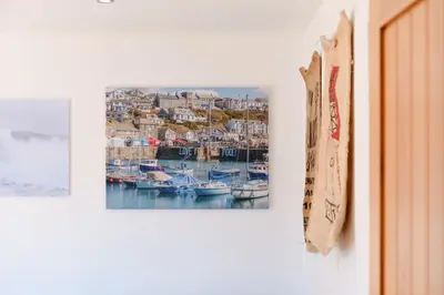 a picture of a harbor with boats on a wall at Finest Retreats - Seadog in Porthleven
