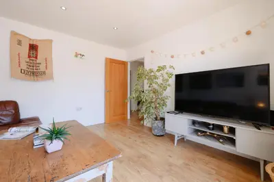 a living room with a large flat screen tv at Finest Retreats - Seadog in Porthleven