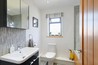 a bathroom with a white sink and a toilet at Finest Retreats - Seadog in Porthleven