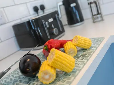 a bunch of vegetables on a cutting board on a counter at The Sandbox in Hayle