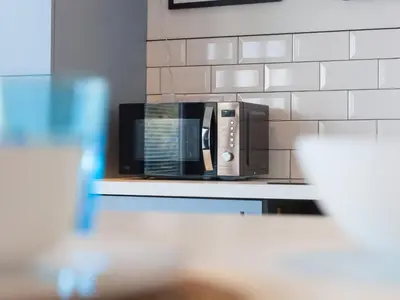 a microwave sitting on a counter in a kitchen at The Sandbox in Hayle