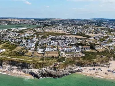 an aerial view of a village on the coast at The Sandbox in Hayle