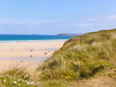 a group of people on a beach near the ocean at The Sandbox in Hayle