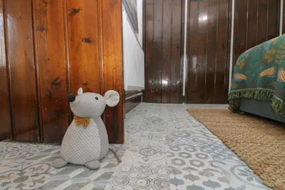 a teddy bear sitting on the floor of a room at Myrtle Cottage in Hayle
