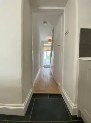 an empty hallway with a hallway leading to a room at Beautiful 2 bed end terrace Victorian town house in Redruth