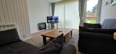a living room with two couches and a tv at 3 Manor Villas Newquay in Newquay