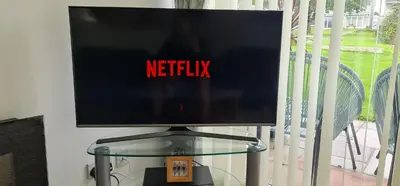 a television on a glass table with the words netflix at 3 Manor Villas Newquay in Newquay