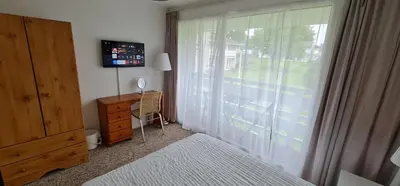 a bedroom with a window with a dresser and a desk at 3 Manor Villas Newquay in Newquay