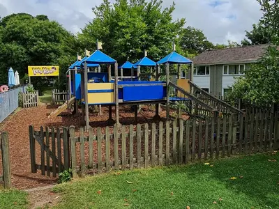 a blue and yellow playground in a yard at 3 Manor Villas Newquay in Newquay
