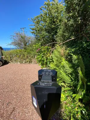 a parking meter sitting on the side of a road at Polrunny Farm sea view Blueberry Cottage with log burner in Boscastle