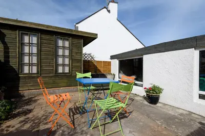 a group of chairs and a table on a patio at Seymour Apartment - Looe in Looe