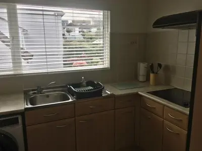 a small kitchen with a sink and a window at Seymour Apartment - Looe in Looe