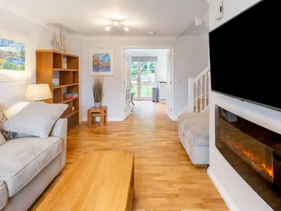 a living room with a large flat screen tv at Holiday Home Sea Echo by Interhome in St Austell