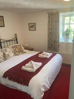 a bedroom with a bed with two towels on it at Bissick Old Mill in Truro