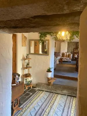 a living room with a couch and a table at Bissick Old Mill in Truro