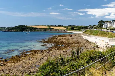 a view of a beach with a boat in the water at The Old Coastguard Station in Falmouth