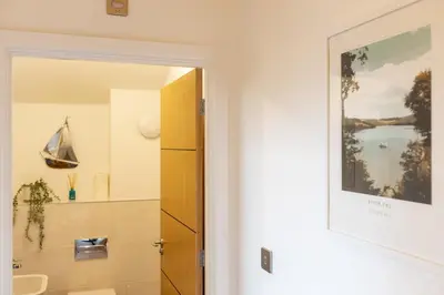 a bathroom with a sink and a mirror at Waves Falmouth-hot tub games room very close to Swanpool beach and Falmouth GC in Falmouth