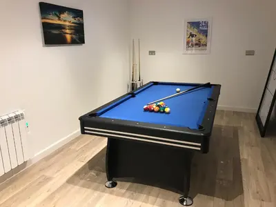a pool table sitting in a room with ahibition at Waves Falmouth-hot tub games room very close to Swanpool beach and Falmouth GC in Falmouth
