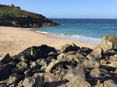 a pile of rocks on a beach next to the ocean at The Grey Mullet Guest House in St Ives