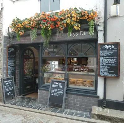 a pastry shop with flowers on the front of it at The Grey Mullet Guest House in St Ives