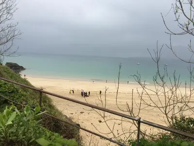 a group of people on a sandy beach at The Grey Mullet Guest House in St Ives