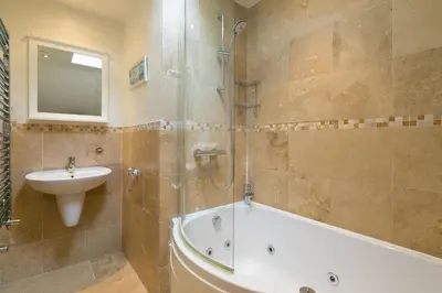 a bathroom with a tub and a sink and a shower at Happy Days in St Ives