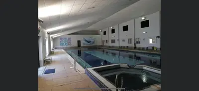 a large indoor swimming pool in a building at 128 Hengar Manor in Bodmin