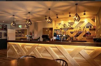 a bar with a wooden counter in a room at 128 Hengar Manor in Bodmin