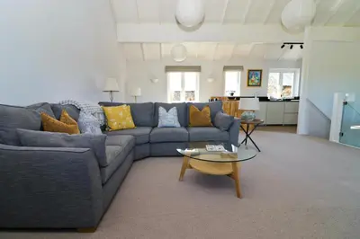 a living room with a couch and a table at Peaceful, rural cottage on the outskirts of Padstow in Padstow