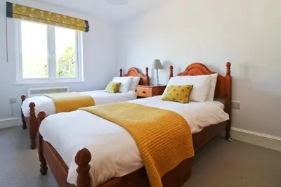 a bedroom with two beds and a window at Peaceful, rural cottage on the outskirts of Padstow in Padstow