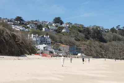 a group of people walking on the beach at Bay Dream - Free parking, close to beach, pet friendly in Carbis Bay