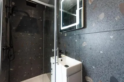 a bathroom with a mirror and a white refrigerator at Bay Dream - Free parking, close to beach, pet friendly in Carbis Bay