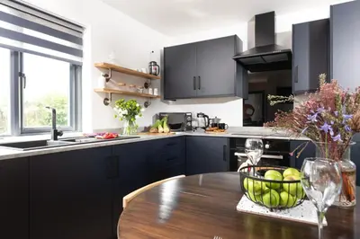 a kitchen with a table with a bowl of apples on it at Bay Dream - Free parking, close to beach, pet friendly in Carbis Bay