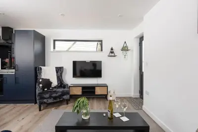 a living room with a tv and a couch at Bay Dream - Free parking, close to beach, pet friendly in Carbis Bay